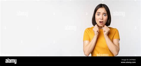 Portrait Of Scared Asian Woman Shaking From Fear Looking Terrified And