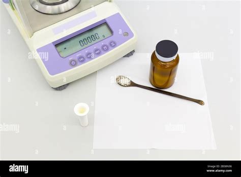 laboratory scale on table with materials in bottles Stock Photo - Alamy