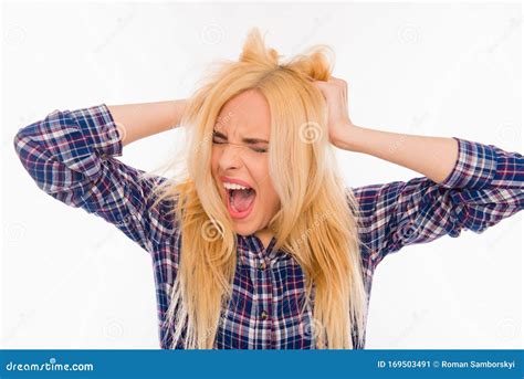 Portrait Of Very Frustrated Young Woman Screaming And Holding Hair