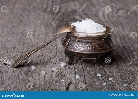 Sea Salt In An Old Utensils And A Small Spoon On A Wooden Table Stock