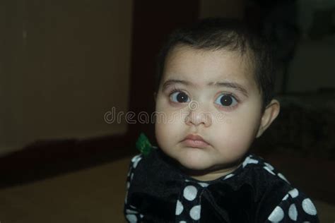 Baby Girl With Lovely Face Big Eyes And Cute Face Gesture Stock Image