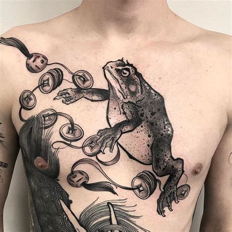 A Man With Tattoos On His Chest Has An Image Of A Frog In The Air