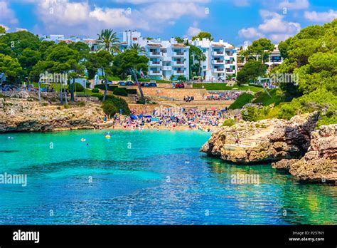 People Enjoying Summer Holiday In Esmeralda Beach In Cala Dor Resort