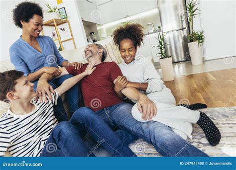 Family Watching TV Together at Home and Having Fun Together Stock Photo - Image of father ...