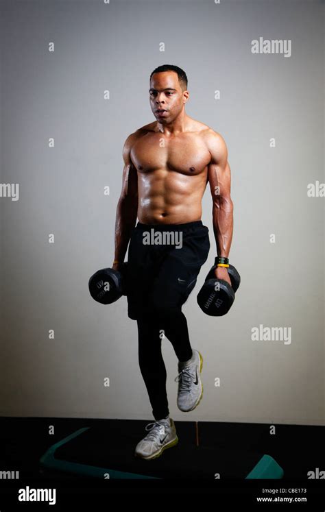 Black Man Working Out At Gym With Barbells And Step Boxes Stock Photo