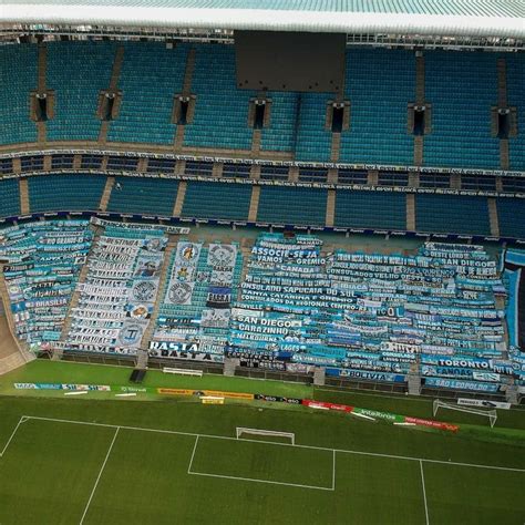 An Aerial View Of A Soccer Stadium With Blue Seats And Green Grass On