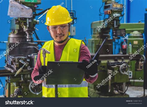 Asian Machinist Safety Suit Checking Job Stock Photo