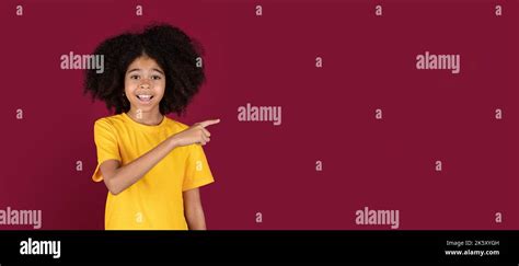 Happy African American Kid Girl Pointing At Copy Space Stock Photo Alamy