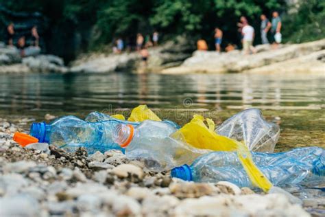 Plastic Pollution In The River Dirty Plastic Bottles And Bags On A