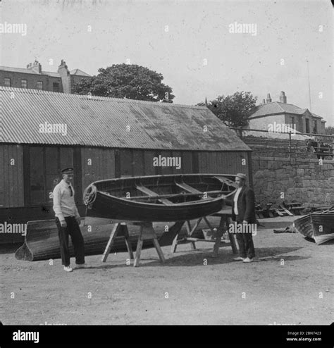 Two Men Pictured With Rowboats In A Yard Dun Laoghaire By National