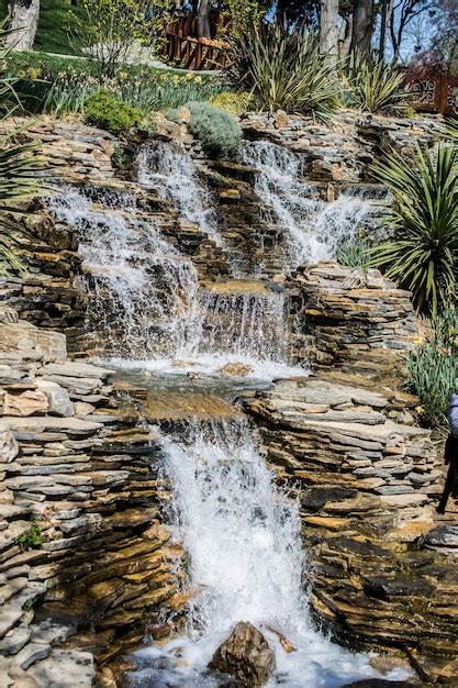 Premium Photo Small Rocky Waterfall Pouring Into A Lake