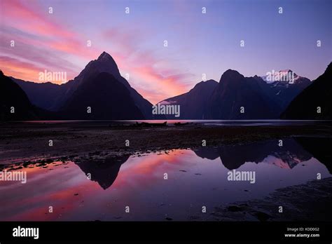 Milford Sound Sunset Behind Mitre Peak With The Mountains Reflected In