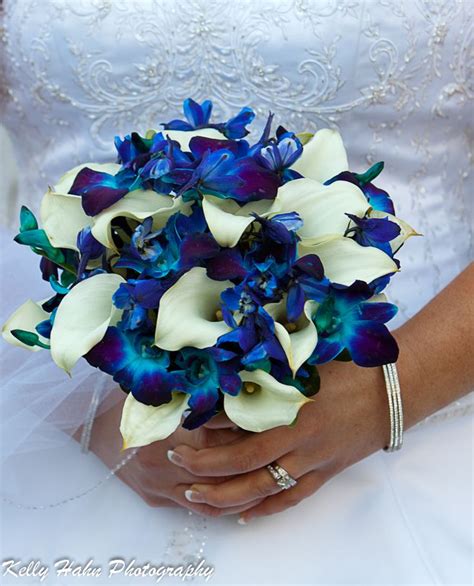 Hand tied bouquet created with white mini calla lilies, electric blue ...