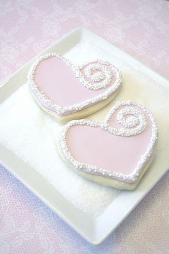 Two Decorated Heart Shaped Cookies On A Plate