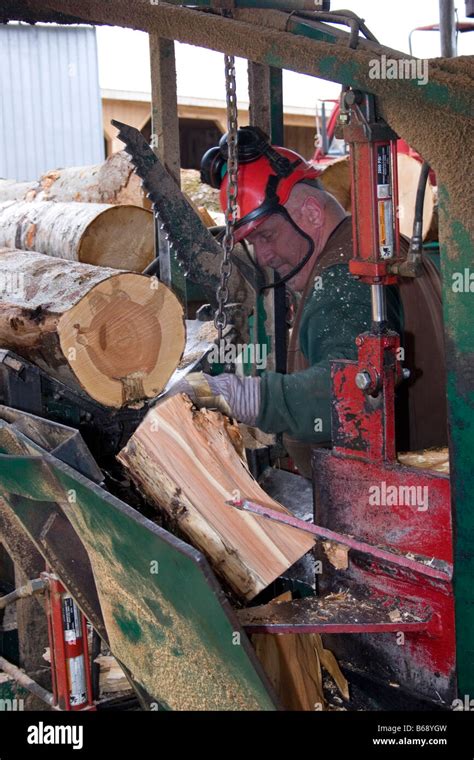 Man Splitting Firewood With Heavy Machinery Stock Photo Alamy