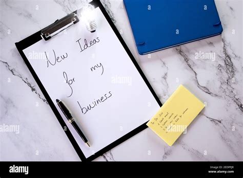 Top view notepad with to-do list, agenda, paper with business idea ...