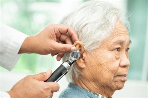 Premium Photo Audiologist Or Ent Doctor Use Otoscope Checking Ear Of