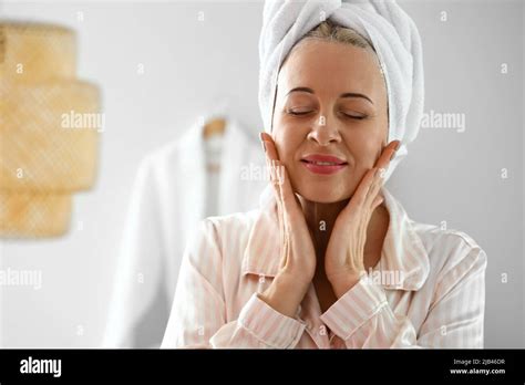 Morning Of Mature Woman Giving Herself Facial Massage At Home Stock Photo Alamy
