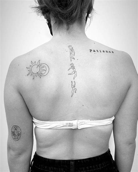 Fine line sun and moon tattoo on the shoulder blade.