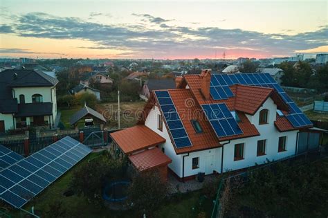 Aerial View Building Roof With Rows Of Blue Solar Photovoltaic Panels For Producing Clean