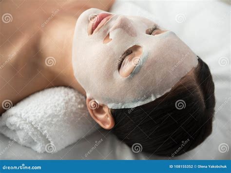 Tranquil Girl Relaxing With Facial Mask At Spa Stock Photo Image Of