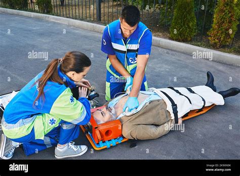 First Aid CPR By Rescue Workers Two Paramedics Performing CPR With