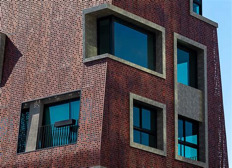 Perforated Metal Panels Cover The Exterior Of This Apartment Building