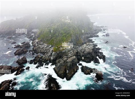 Stunning Aerial View Of Steep Cliff And Lighthouse On The Top Of Hill