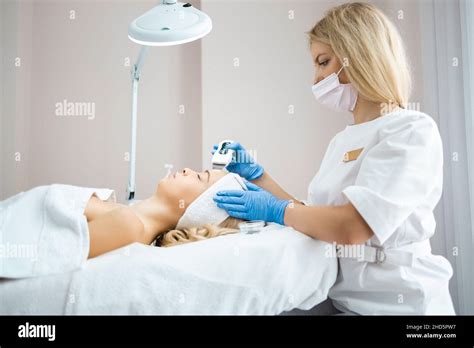 Doctor Cosmetologist Makes Professional Ultrasound Cleaning Of The