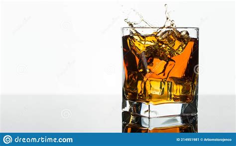 Glass Of Whiskey Or Brandy Splash In A Glass On White Background