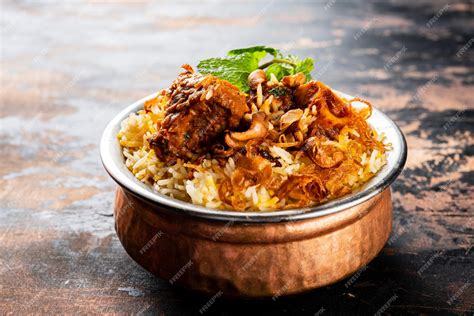 Premium Photo Mutton Biryani Served In A Golden Dish Isolated On Dark