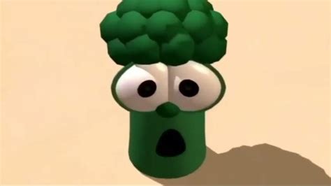 A Green Cartoon Broccoli With Eyes Sticking Out Of Its Head And Mouth