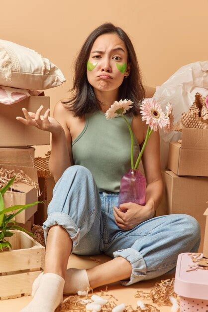 Confused Hesitant Dissatisfied Asian Woman Shrugs Shoulders Holds Vase