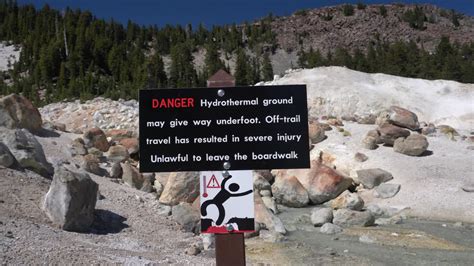 A Danger Sign Warning All Visitors To Stay On The Pedestrian Walkway At