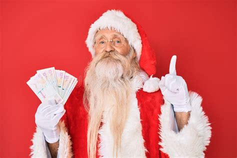 Old Senior Man With Grey Hair And Long Beard Wearing Santa Claus