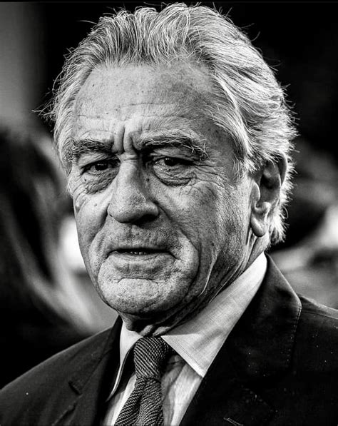 Black And White Photograph Of An Older Man In Suit And Tie Looking At