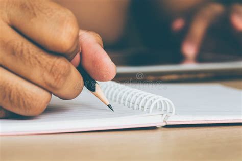 Man Is Writing With A Pencil On A Piece Of Paper Stock Image Image Of