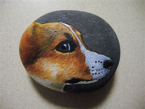 A Painted Rock With A Dogs Face On It