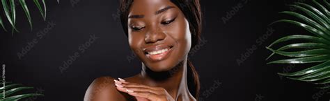 African American Naked Woman Touching Body Near Green Palm Leaves