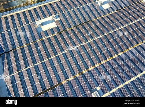 Aerial View Of Many Photo Voltaic Solar Panels Mounted Of Industrial