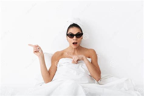 Beautiful Shocked Woman With Towel On Head Lies In Bed Under Blanket