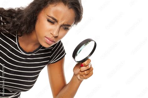 Beautiful Young Dark Skinned Woman Looking Trough The Magnifying Glass