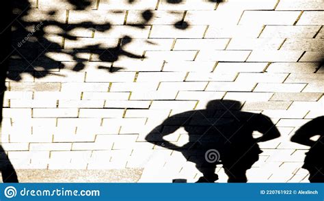 Blurry Shadow Silhouette Of A Person Walking City Street Stock Photo