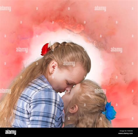 Senior And Junior Sisters Embracing And Kissing On Abstract Background