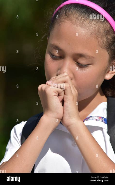 Youthful Female Student In Prayer With Books Stock Photo Alamy