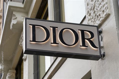 Oslo, Norway - October 15, 2022: Close up of Dior store projecting sign on the building ...