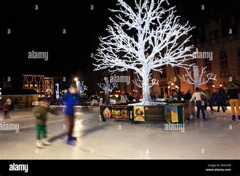 Panned camera effect on People skating on the Christmas Ice rink ...