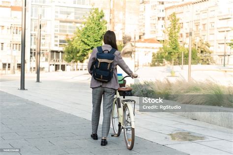 Rear View Of An Asian Businesswoman Commuting With A Bike Stock Photo