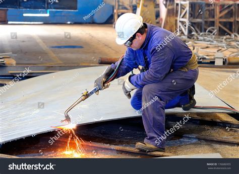 A Welder Working At Shipyard In Day Time Stock Photo 176686955