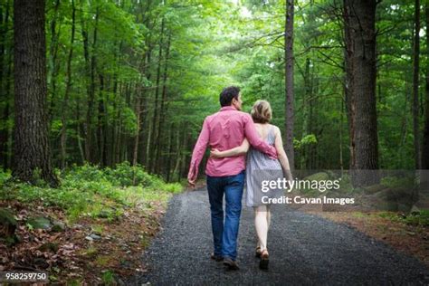 126 Mature Couple Walking With Arms Around Each Other Rear View Stock